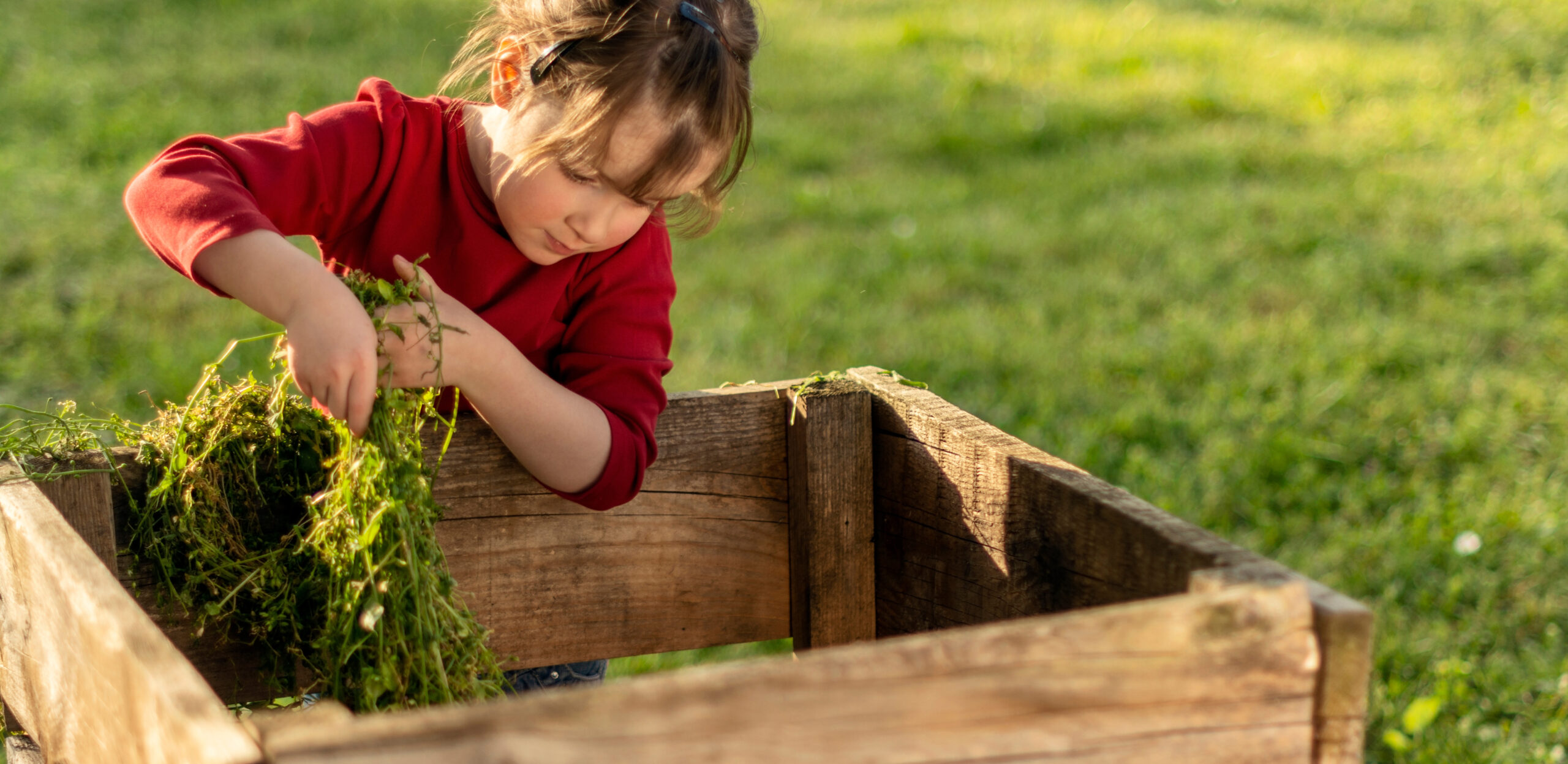 Girl composting in the yard